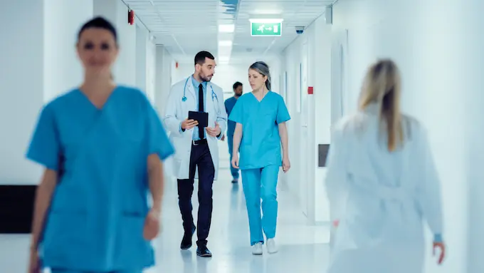 Doctors and nurses walking in a hospital hallway | Schendel Pest Control in healthcare facilities serving Kansas, Missouri, and Arizona