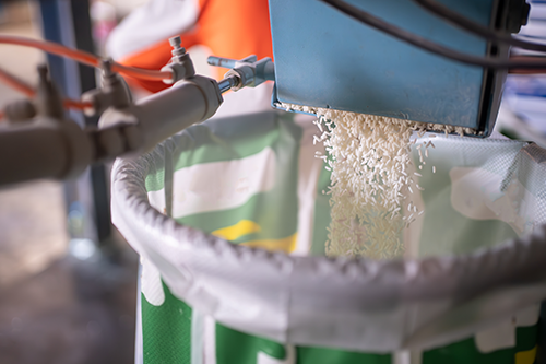 rice being portioned out into a bag